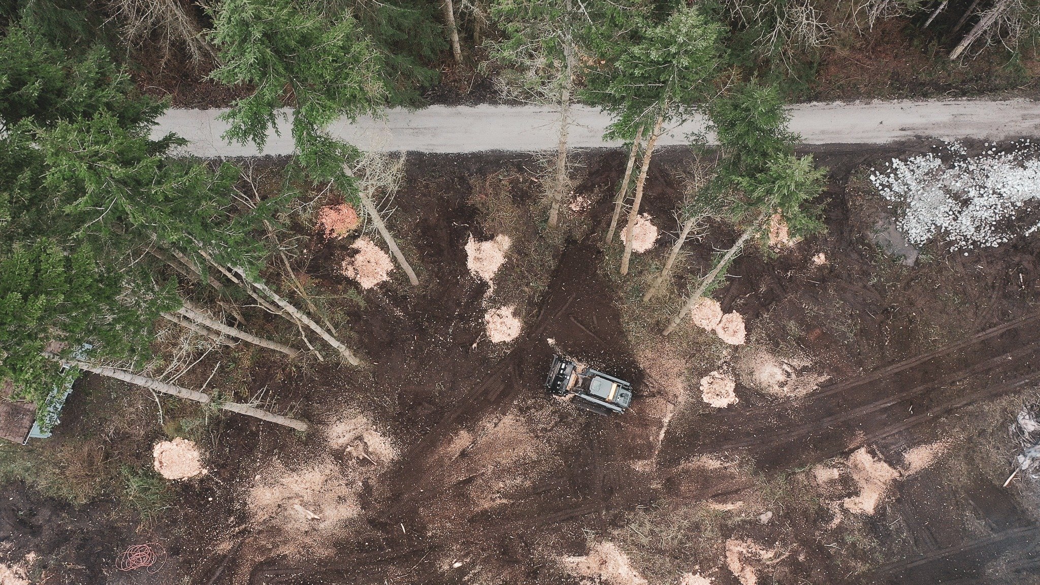 Aerial view of a land clearing site with felled trees